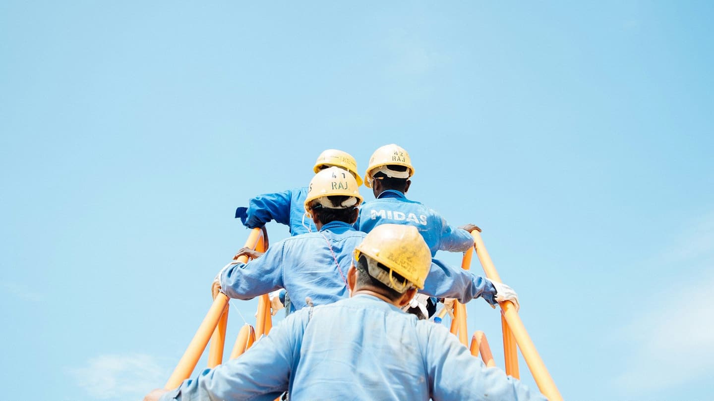 Construction workers in hard hats on site